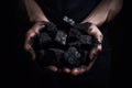 Male hands with black coal