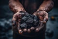 Male hands with black coal