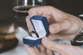 Male hands with blue velvet box containing payments smart ring