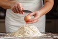 male hands break the egg into flour for pasta on old wooden kitchen table. Royalty Free Stock Photo