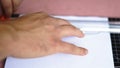 Male hands measuring and cutting a paper sheet whit a manual guillotine