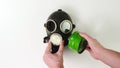 Male hands check green filter on gas mask on white background. Close up. Royalty Free Stock Photo