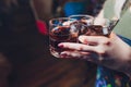 Male hands cheer with glasses of shot or liqueur. Friends drink shot or liqueur and cheers. Male hands cheer with Royalty Free Stock Photo