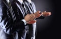 Male hands clapping on black