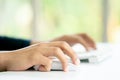 Male Hands Clicking Wireless Computer Mouse Laptop computer on Office Table Royalty Free Stock Photo