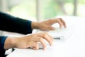 Male Hands Clicking Wireless Computer Mouse Laptop computer on Office Table