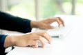 Male Hands Clicking Wireless Computer Mouse Laptop computer on Office Table Royalty Free Stock Photo