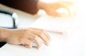 Male Hands Clicking Wireless Computer Mouse Laptop computer on Office Table Royalty Free Stock Photo