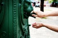 Male hands close-up, unrecognizable tourist washing hands in street fountain Royalty Free Stock Photo