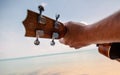 Male hands closeup, man playing ukulele on tropical beach, music, art, travel and vacation concept Royalty Free Stock Photo