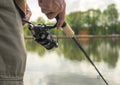 Male hands closeup with reel rod or spoon-bait. Fishing concept Royalty Free Stock Photo