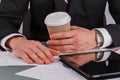 Male hands with coffee cup and documents on office desk. Royalty Free Stock Photo