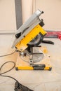 Male hands of  construction worker sawing and cutting parts of  electric miter saw from  wooden board. wood board cutting process Royalty Free Stock Photo