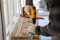 Male hands of construction worker tighten and fix screws and self-tapping screw with electric cordless screwdriver for home