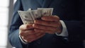 Male hands counting money cash close up. Unknown man calculating dollar bills. Royalty Free Stock Photo