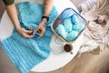 Male hands crochet handmade artwork use wool yarn and hook over table with coffee Royalty Free Stock Photo