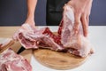 Male hands cut the carcass of a large Turkey on a wooden board. Fresh meat Royalty Free Stock Photo