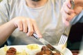 Male hands cutting and eating sausage Royalty Free Stock Photo