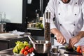 Male hands cutting food at kitchen table. Closeup chef hands cut vegetables.