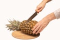 Male hands cutting and peeling fresh pineapple close up isolated Royalty Free Stock Photo