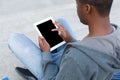 Male hands with digital tablet closeup,over shoulder shot outdoors