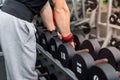 Male hands with dumbbells in gym close up Royalty Free Stock Photo