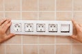 Male hands finishing mounting an electrical wall socket Royalty Free Stock Photo