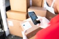 Male hands with gloves taking a picture of a shipping label