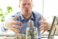 Male hands grabbing big fat jar full of US currency as greed gesture Royalty Free Stock Photo