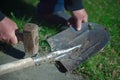 Man fixing broken shovel