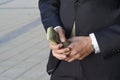 Businessman in a suit with a bundle of cash. financial capital. Royalty Free Stock Photo