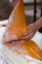 Male hands hold fish meat.