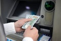 Male hands hold money dollars received from an ATM