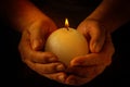 Male hands holding burning candle with flame Royalty Free Stock Photo