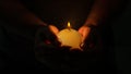 Male hands holding burning candle with flame Royalty Free Stock Photo