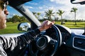 Male hands holding car steering wheel. Hands on steering wheel of a car driving. Young Man driving a car inside cabin. Multimedia