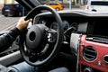 Male hands holding car steering wheel. Hands on steering wheel of a car driving. Young Man driving a car inside cabin. Multimedia