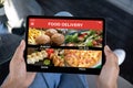 male hands holding computer tablet with app food delivery screen Royalty Free Stock Photo