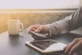 Male hands holding credit card and using Tablet with a cup of coffee on the table. Royalty Free Stock Photo