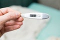 Male hands holding a digital thermometer Royalty Free Stock Photo