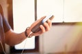 Male hands holding mobile phone, checking social networks on smartphone at home