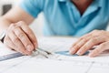 Male hands holding a pair of compasses and a protractor Royalty Free Stock Photo