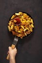 Male hands holding  pan with fresh fried potatoes Royalty Free Stock Photo