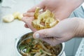 Male hands holding potato peels over bowl of vegetable peelings closeup. Separate waste collection, waste free.