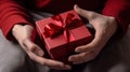 male hands holding a red gift box to a woman, female holiday gift generative ai Royalty Free Stock Photo