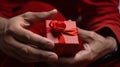 male hands holding a red gift box to a woman, female holiday gift generative ai Royalty Free Stock Photo