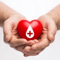 Male hands holding red heart with donor sign Royalty Free Stock Photo