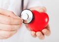 Male hands holding red heart and stethoscope Royalty Free Stock Photo