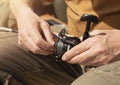 Male hands holding spinning rod, spoon-bait and and fixing or adjusting it before or after fishing, close up Royalty Free Stock Photo