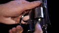 Male hands holding steel revolver closeup, killer preparing weapon, protection